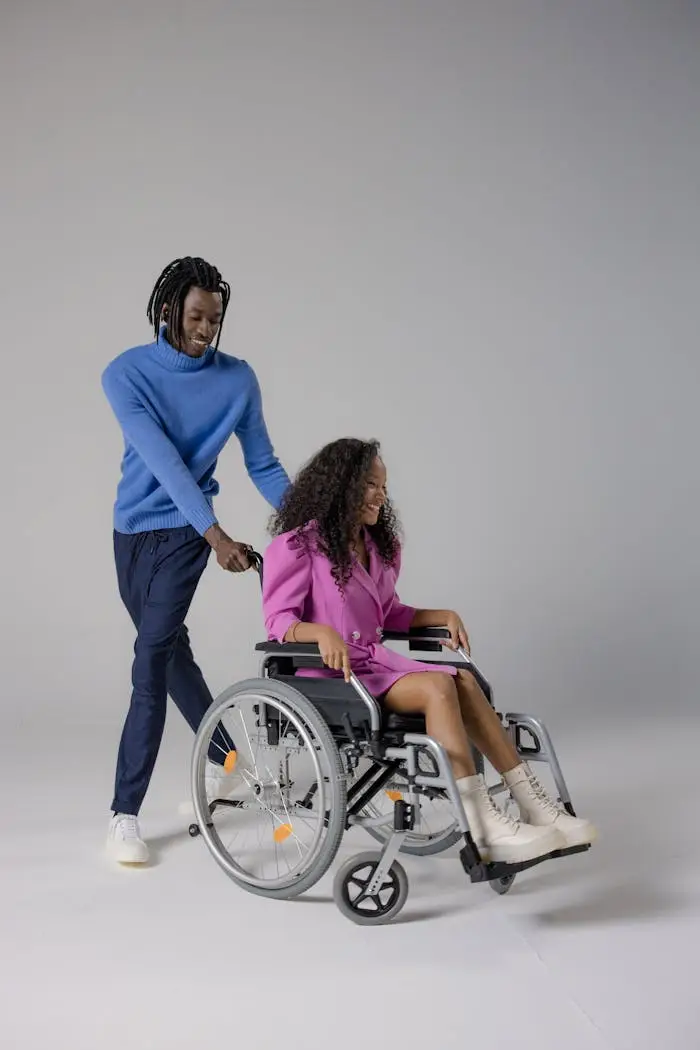 Man assisting woman in wheelchair, showcasing compassion and care.